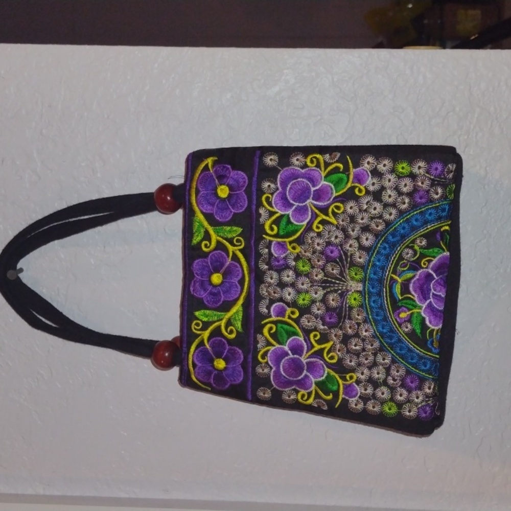 This is a cute little multicolor mini purse with purple flowers.